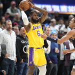 
              Los Angeles Lakers forward LeBron James, left, looks to pass the ball as Denver Nuggets forward Aaron Gordon defends in the first half of an NBA basketball game Wednesday, Oct. 26, 2022, in Denver. (AP Photo/David Zalubowski)
            