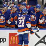 
              New York Islanders center Kyle Palmieri (21) celebrates with his teammates after scoring on New York Rangers goaltender Jaroslav Halak (41) in the second period of an NHL hockey game, Wednesday, Oct. 26, 2022, in Elmont, N.Y. (AP Photo/John Minchillo)
            