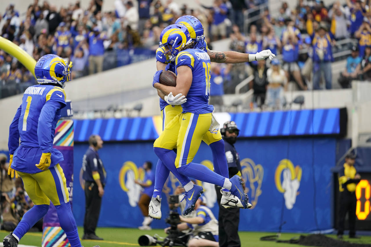 Los Angeles Rams wide receiver Ben Skowronek, with ball, leaps in celebration after scoring a touch...