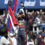 
              Mexican Formula One Red Bull driver Sergio "Checo" Perez waves at fans while holding a Mexican national flag after an exhibition race through the streets of Guadalajara, Mexico, Tuesday, Oct. 25, 2022. Perez will compete in the upcoming Mexico Grand Prix in Mexico City. (AP Photo)
            