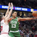 
              Boston Celtics' Malcolm Brogdon (13) loses control of the ball off pressure from Chicago Bulls' Goran Dragic during the first half of an NBA basketball game Monday, Oct. 24, 2022, in Chicago. (AP Photo/Charles Rex Arbogast)
            