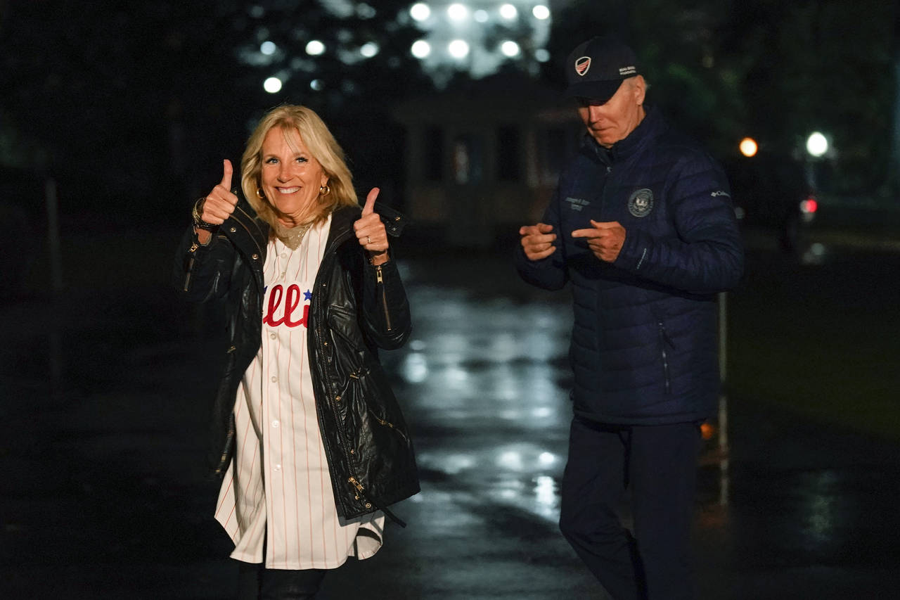 First lady Jill Biden gestures in support of the Philadelphia Phillies as she and President Joe Bid...