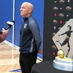 
              FILE - North Carolina Courage coach Paul Riley is interviewed by a reporter next to the trophy for the National Women's Soccer League championship during a media event at Nike in Beaverton, Ore., Sept. 20, 2018. An independent investigation into the scandals that erupted in the National Women's Soccer League last season found emotional abuse and sexual misconduct were systemic in the sport, impacting multiple teams, coaches and players, according to a report released Monday, Oct. 3, 2022. U.S. Soccer commissioned the investigation after former NWSL players Sinead Farrelly and Mana Shim came forward with allegations of harassment and sexual coercion dating back a decade involving former coach Paul Riley. (AP Photo/Anne M. Peterson, File)
            