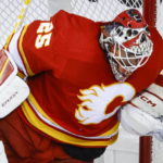 
              Calgary Flames goalie Jacob Markstrom stops the puck during the first period of the team's NHL hockey game against the Carolina Hurricanes on Saturday, Oct. 22, 2022, in Calgary, Alberta. (Jeff McIntosh/The Canadian Press via AP)
            