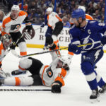 
              Philadelphia Flyers goaltender Carter Hart (79) and center Zack MacEwen (17) team up to stop a shot by Tampa Bay Lightning center Steven Stamkos (91) during the second period of an NHL hockey game Tuesday, Oct. 18, 2022, in Tampa, Fla. (AP Photo/Chris O'Meara)
            