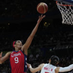 
              United States' A'ja Wilson, left, shoots over China's Yang Liwei during their gold medal game at the women's Basketball World Cup in Sydney, Australia, Saturday, Oct. 1, 2022. (AP Photo/Rick Rycroft)
            