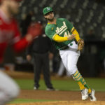 
              Oakland Athletics third baseman Ernie Clement throws out Los Angeles Angels' Taylor Ward at first base during the second inning of a baseball game, Monday, Oct. 3, 2022, in Oakland, Calif. (AP Photo/D. Ross Cameron)
            