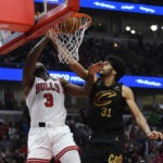 
              Chicago Bulls' Andre Drummond (3) dunks against Cleveland Cavaliers' Jarrett Allen (31) during the second half of an NBA basketball game Saturday, Oct. 22, 2022, in Chicago. (AP Photo/Paul Beaty)
            