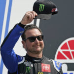 
              FILE - NASCAR Cup Series driver Kurt Busch tips his cap prior to the NASCAR Cup Series auto race at the New Hampshire Motor Speedway, Sunday, July 17, 2022, in Loudon, N.H.  Busch announced Saturday, Oct. 15 he will miss the rest of this season with a concussion and will not compete full-time in 2023.  The 44-year-old made his announcement at Las Vegas Motor Speedway, his home track and where he launched his career on the bullring as a child. He choked up when he said doctors told him “it is best for me to ‘shut it down.'”   (AP Photo/Charles Krupa, File)
            