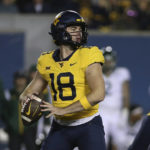 
              West Virginia quarterback JT Daniels (18) looks for a receiver during the first half of the team's NCAA college football game against Baylor in Morgantown, W.Va., Thursday, Oct. 13, 2022. (AP Photo/Kathleen Batten)
            