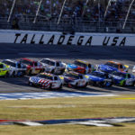 
              Ryan Blaney (12) leads the field through the tri-oval during a NASCAR Cup Series auto race Sunday, Oct. 2, 2022, in Talladega, Ala. (AP Photo/Butch Dill)
            