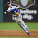 
              Kansas City Royals shortstop Bobby Witt Jr. attempts but cannot throw out Cleveland Guardians' Gabriel Arias at first base after committing a fielding error during the sixth inning of a baseball game, Monday, Oct. 3, 2022, in Cleveland. (AP Photo/Ron Schwane)
            