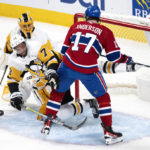 
              Pittsburgh Penguins defenseman Pierre-Olivier Joseph (73) takes a hit from Montreal Canadiens right wing Josh Anderson (17) in front of Penguins goaltender Casey DeSmith, top left, during second-period NHL hockey game action in Montreal, Monday, Oct. 17, 2022. (Paul Chiasson/The Canadian Press via AP)
            