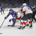 
              Buffalo Sabres' Casey Mittelstadt skates with the puck against Florida Panthers' Aleksander Barkov during an NHL hockey game Saturday, Oct. 15, 2022, in Buffalo, N.Y. (Joseph Cooke/The Buffalo News via AP)
            