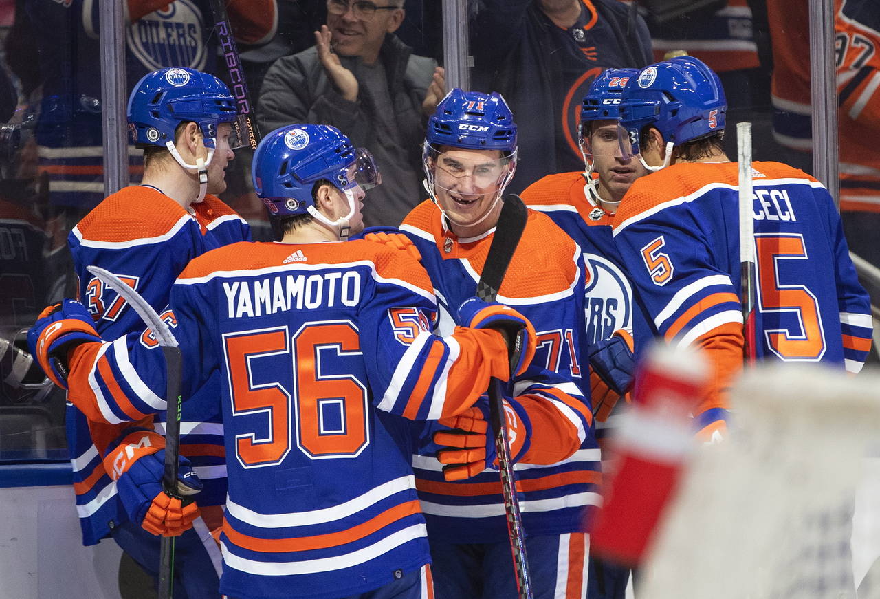 Edmonton Oilers' Ryan McLeod (71) celebrates with teammates after his goal against the Calgary Flam...