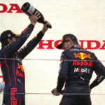 
              Red Bull driver Max Verstappen, right, of the Netherlands is sprayed with champagne by second placed teammate Sergio Perez of Mexico on podium during the Japanese Formula One Grand Prix at the Suzuka Circuit in Suzuka, central Japan, Sunday, Oct. 9, 2022.(AP Photo/Toru Hanai)
            