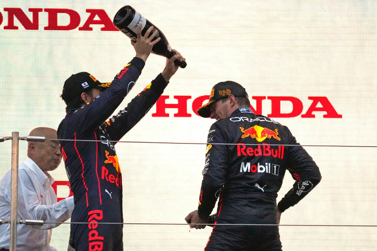 Red Bull driver Max Verstappen, right, of the Netherlands is sprayed with champagne by second place...
