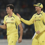 
              Australia's Pat Cummins, left, celebrates with teammate after the dismissal of India's captain Rohit Sharma during the third T20 cricket match between India and Australia, in Hyderabad, India, Sunday, Sept. 25, 2022. (AP Photo/Mahesh Kumar A)
            