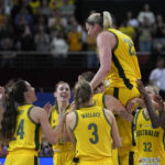 
              Australia's Lauren Jackson, center, is lifted by her fellow players as they celebrate winning their bronze medal game against Canada at the women's Basketball World Cup in Sydney, Australia, Saturday, Oct. 1, 2022. (AP Photo/Rick Rycroft)
            