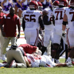 
              Oklahoma quarterback Dillon Gabriel (8) its looked at by team staff after a late hit by TCU during the first half of an NCAA college football game Saturday, Oct. 1, 2022, in Fort Worth, Texas. (AP Photo/Ron Jenkins)
            