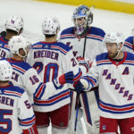 
              New York Rangers goaltender Igor Shesterkin, top, celebrates with teammates after their 7-3 win against the Minnesota Wild in an NHL hockey game Thursday, Oct. 13, 2022, in St. Paul, Minn. (AP Photo/Abbie Parr)
            