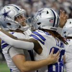 
              Dallas Cowboys quarterback Cooper Rush, left, and wide receiver CeeDee Lamb (88) celebrate after Rush threw a touchdown pass to Lamb in the second half of a NFL football game against the Washington Commanders in Arlington, Texas, Sunday, Oct. 2, 2022. (AP Photo/Ron Jenkins)
            
