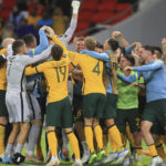 
              FILE - Australian players celebrate after winning in a penalty shoot-out during the World Cup 2022 qualifying play-off soccer match between Australia and Peru in Al Rayyan, Qatar, Monday, June 13, 2022. (AP Photo/Hussein Sayed, File)
            
