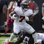 
              Tampa Bay Buccaneers running back Leonard Fournette (7) is brought down by Atlanta Falcons defensive tackle Timmy Horne (93) during the second half of an NFL football game Sunday, Oct. 9, 2022, in Tampa, Fla. (AP Photo/Chris O'Meara)
            