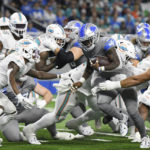 
              Detroit Lions running back Jamaal Williams rushes through the Miami Dolphins line during the first half of an NFL football game, Sunday, Oct. 30, 2022, in Detroit. (AP Photo/Lon Horwedel)
            