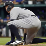 
              New York Yankees' Aaron Judge ducks down while leading off from third base during eighth inning in the first baseball game of a doubleheader against the Texas Rangers in Arlington, Texas, Tuesday, Oct. 4, 2022. (AP Photo/LM Otero)
            