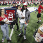 
              Oakland Raiders' Davante Adams, center, a former Fresno State player, has his jersey number retired at halftime of Fresno State's NCAA college football game against San Jose State in Fresno, Calif., Saturday, Oct. 15, 2022. (AP Photo/Gary Kazanjian)
            
