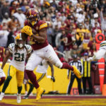 
              Washington Commanders running back Antonio Gibson catches a touchdown pass in front of Green Bay Packers safety Darnell Savage (26) during the first half of an NFL football game Sunday, Oct. 23, 2022, in Landover, Md. (AP Photo/Patrick Semansky)
            