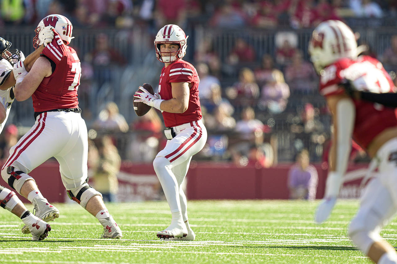 Wisconsin quarterback Graham Mertz (5) looks to pass against Purdue during the first half of an NCA...