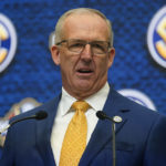 
              FILE - Southeastern Conference Commissioner Greg Sankey speaks during SEC Media Days, July 18, 2022, in Atlanta. The third in-person meeting of conference commissioners who manage the College Football Playoff since an August directive from their bosses to expand the postseason format ended without a resolution but not without optimism. “There's a will to try and that will is still there,” Sankey said Thursday, Oct. 20, 2022. (AP Photo/John Bazemore, File)
            