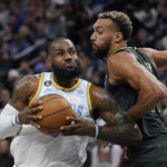 
              Los Angeles Lakers forward LeBron James, left, works toward the basket against Minnesota Timberwolves center Rudy Gobert, right, during the first half of an NBA basketball game, Friday, Oct. 28, 2022, in Minneapolis. (AP Photo/Abbie Parr)
            