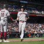 
              Arizona Diamondbacks' Jordan Luplow (8) celebrates with Josh Rojas (10) after scoring against the San Francisco Giants on a double by Christian Walker during the seventh inning of a baseball game in San Francisco, Saturday, Oct. 1, 2022. (AP Photo/Godofredo A. Vásquez)
            