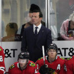 
              Chicago Blackhawks head coach Luke Richardson, top center, stands behind the bench during the second period of an NHL hockey game against the Detroit Red Wings, Oct. 21, 2022, in Chicago. (AP Photo/David Banks)
            