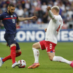 
              FILE - France's Karim Benzema, left, challenges for the ball with Denmark's Victor Nelsson during the UEFA Nations League soccer match between France and Denmark at the Stade de France in Saint Denis near Paris, France, Friday, June 3, 2022. (AP Photo/Jean-Francois Badias, File)
            