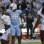 
              North Carolina tight end Kamari Morales (88) signals for a first down after he made a reception while Virginia Tech defensive back Nasir Peoples (5) looks on during the second half of an NCAA college football game in Chapel Hill, N.C., Saturday, Oct. 1, 2022. (AP Photo/Chris Seward)
            
