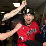 
              Cleveland Guardians' Josh Naylor, right, is doused as the team celebrates in the clubhouse after defeating the Tampa Bay Rays in the wild card baseball playoff series, Saturday, Oct. 8, 2022, in Cleveland. (AP Photo/David Dermer)
            