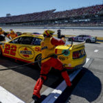
              The pit crew for Joey Logano run to the car during a pit stop during a NASCAR Cup Series auto race Sunday, Oct. 2, 2022, in Talladega, Ala. (AP Photo/Butch Dill)
            