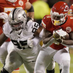 
              Kansas City Chiefs running back Jerick McKinnon, right, runs for a first down as Las Vegas Raiders defensive tackle Kendal Vickers (95) defends during the first half of an NFL football game Monday, Oct. 10, 2022, in Kansas City, Mo. (AP Photo/Charlie Riedel)
            