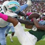 
              Tulane defensive back Jarius Monroe (11) breaks up a pass intended for South Florida wide receiver Xavier Weaver (10) during the second half of an NCAA college football game Saturday, Oct. 15, 2022, in Tampa, Fla. (AP Photo/Chris O'Meara)
            