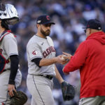 
              Cleveland Guardians pitcher Aaron Civale, center, hands the ball to manager Terry Francona as he leaves the game after giving up a three-run home run to the New York Yankees during the first inning of Game 5 of an American League Division baseball series, Tuesday, Oct. 18, 2022, in New York. (AP Photo/John Minchillo)
            
