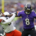 
              Baltimore Ravens quarterback Lamar Jackson (8) tries to fend off Cleveland Browns linebacker Deion Jones (54) in the second half of an NFL football game, Sunday, Oct. 23, 2022, in Baltimore. (AP Photo/Julio Cortez)
            