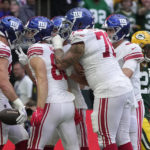 
              New York Giants tight end Daniel Bellinger (82), left, celebrates with team-mates after scoring a touchdown during an NFL game between the New York Giants and the Green Bay Packers at the Tottenham Hotspur stadium in London, Sunday, Oct. 9, 2022. (AP Photo/Kin Cheung)
            