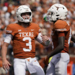 
              Texas quarterback Quinn Ewers (3) and wide receiver Xavier Worthy (8) celebrate after they connected on a touchdown pass against Iowa State during the second half of an NCAA college football game, Saturday, Oct. 15, 2022, in Austin, Texas. (AP Photo/Eric Gay)
            