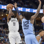 
              Brooklyn Nets guard Kyrie Irving (11) shoots against Memphis Grizzlies guard Ja Morant (12) in the first half of an NBA basketball game, Monday, Oct. 24, 2022, in Memphis, Tenn. (AP Photo/Brandon Dill)
            