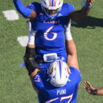 
              Kansas quarterback Jalon Daniels (6) celebrates his touchdown against Iowa State with teammate lineman Dominick Puni (67) during the first half of an NCAA college football game, Saturday, Oct. 1, 2022, in Lawrence, Kan. (AP Reed/Hoffmann)
            