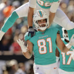 
              Miami Dolphins tight end Durham Smythe (81) reacts as tight end Mike Gesicki (88) leaps over his shoulders after Smythe scored a touchdown against the New York Jets during the second quarter of an NFL football game, Sunday, Oct. 9, 2022, in East Rutherford, N.J. (AP Photo/Adam Hunger)
            